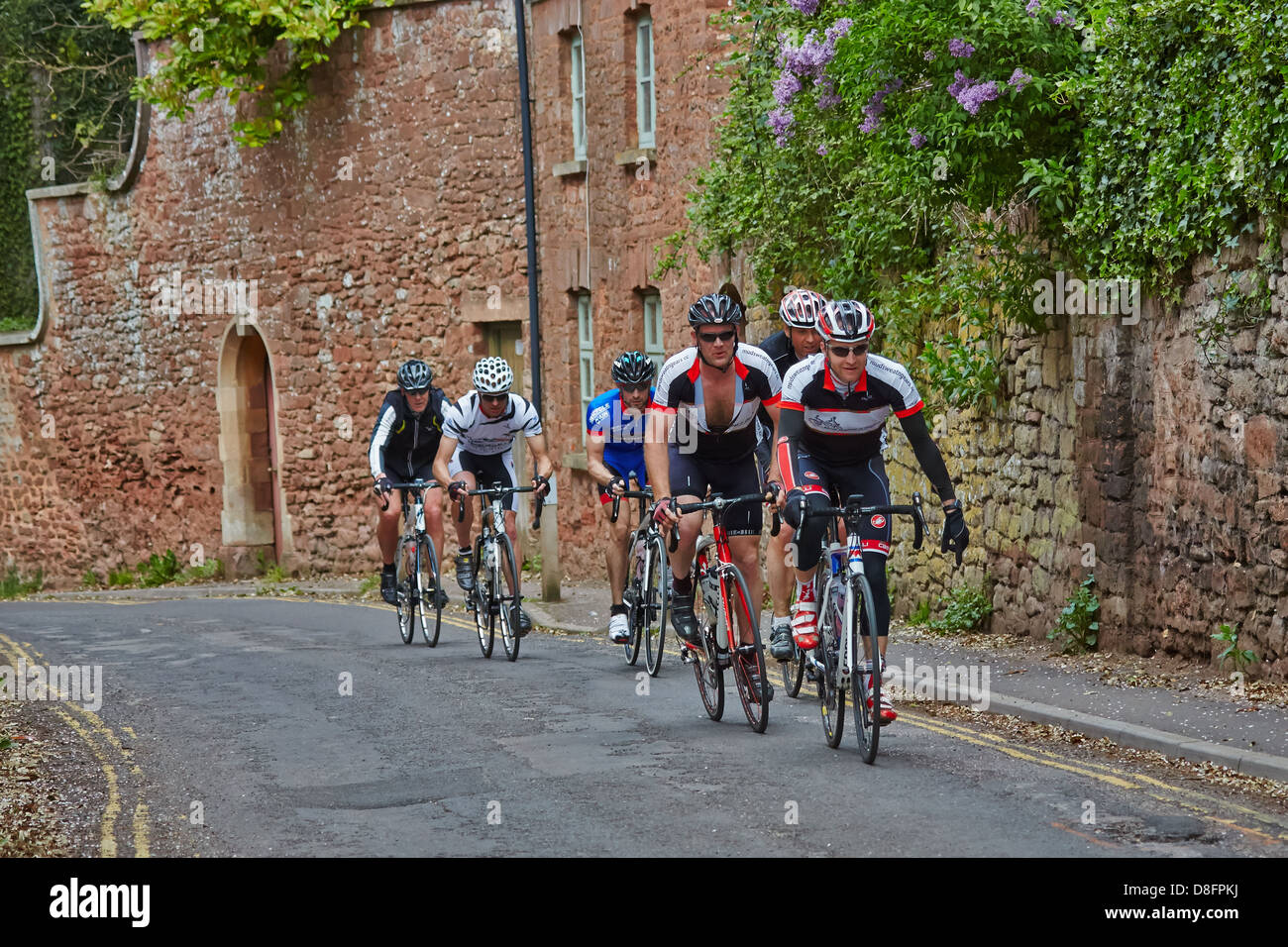 Cyclists taking part in the Coast to Coast Cycle Challenge 2013 pass through Bishops Lydeard Stock Photo
