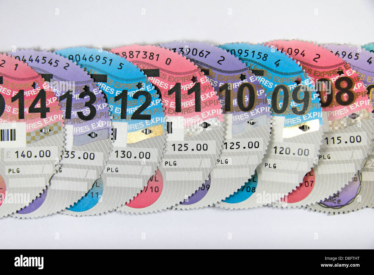 A line of UK tax discs (UK car) showing the steady increase in price from £115 in 2007-8 to £140 in 2013-14. Stock Photo