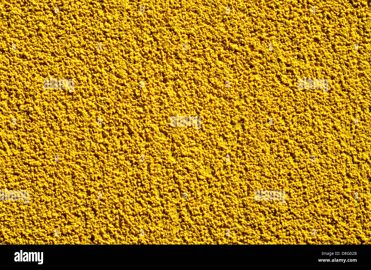 Detail of a rugged yellow wall suitable as background Stock Photo