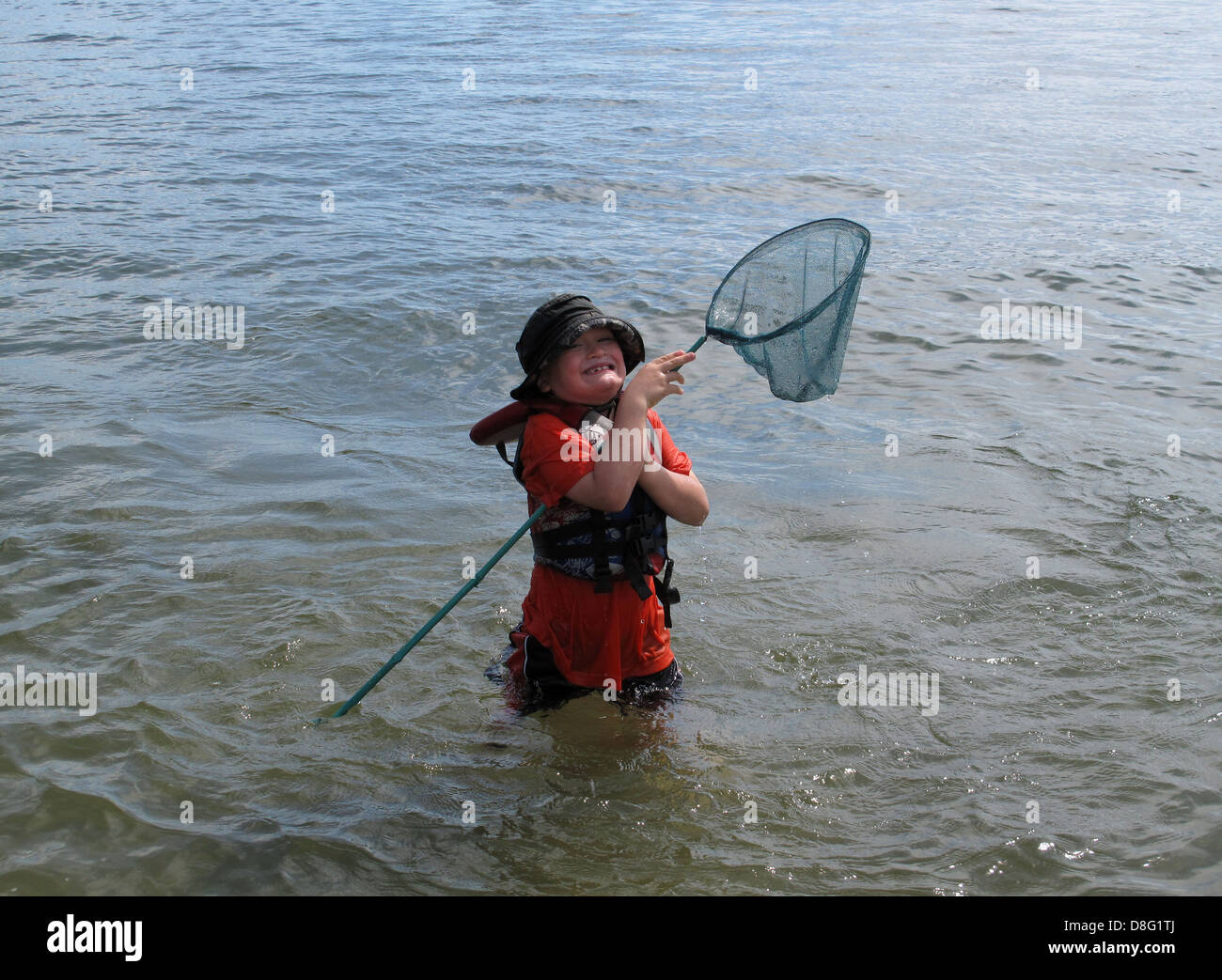 Young boy wading fishing net hi-res stock photography and images