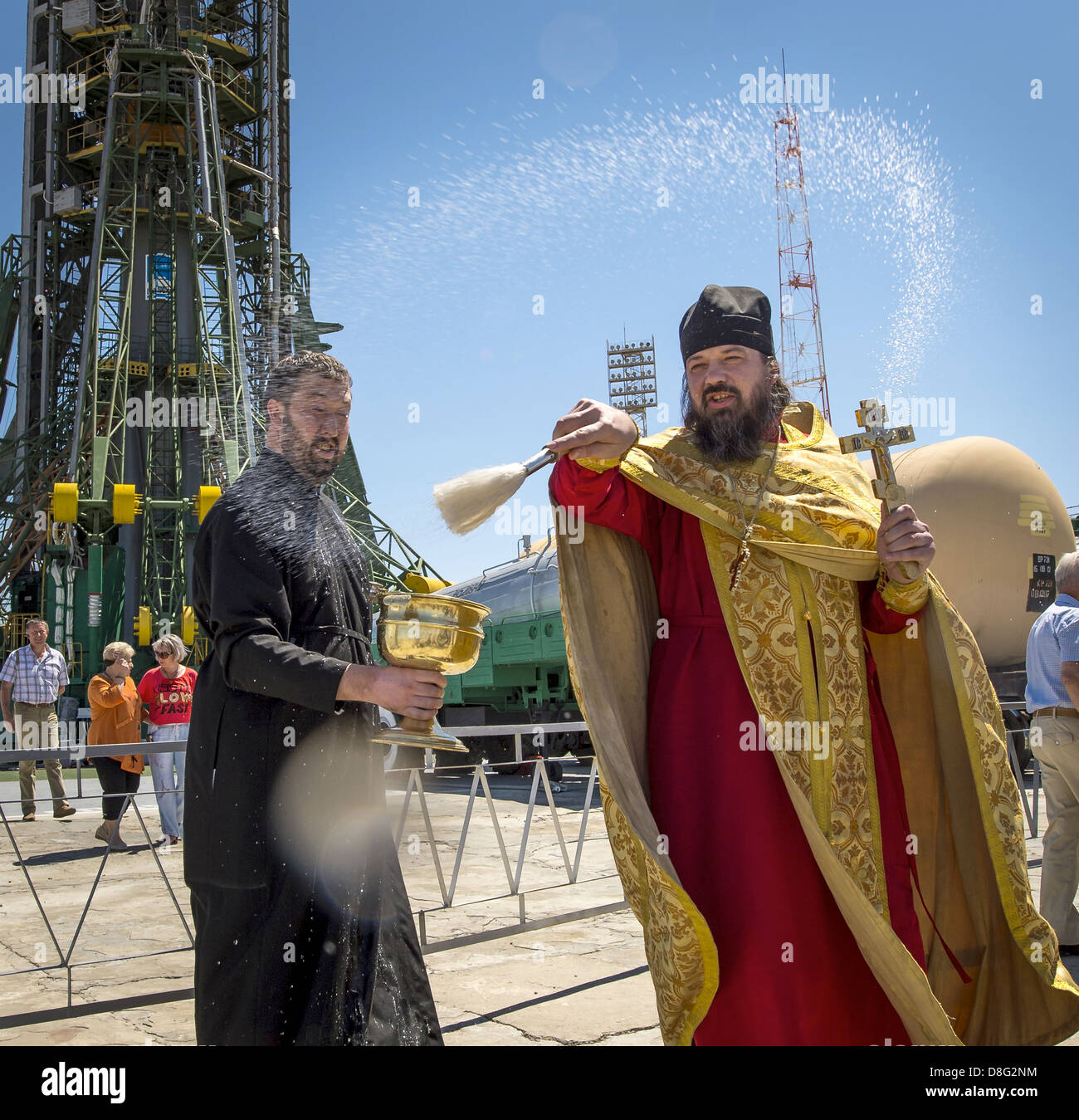 A Russian Orthodox Priest blesses members of the media shortly after having blessed the Soyuz rocket at the Baikonur Cosmodrome Launch pad May 27, 2013 in Kazakhstan. The launch of the Soyuz rocket to the International Space Station with Expedition 36/37 crew is scheduled for Wednesday. Stock Photo