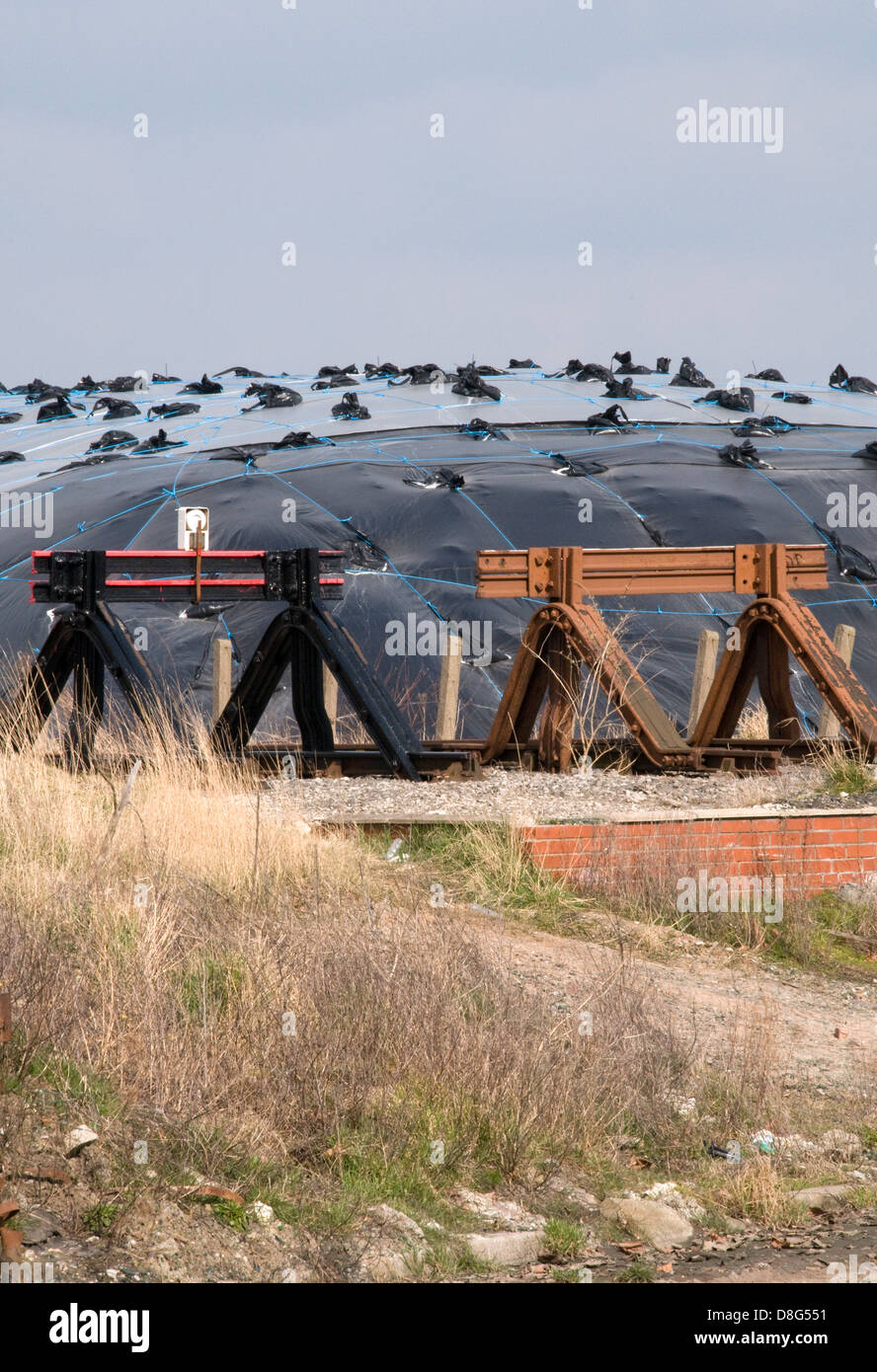 Tires and railway  buffers in an industrial wasteland Stock Photo
