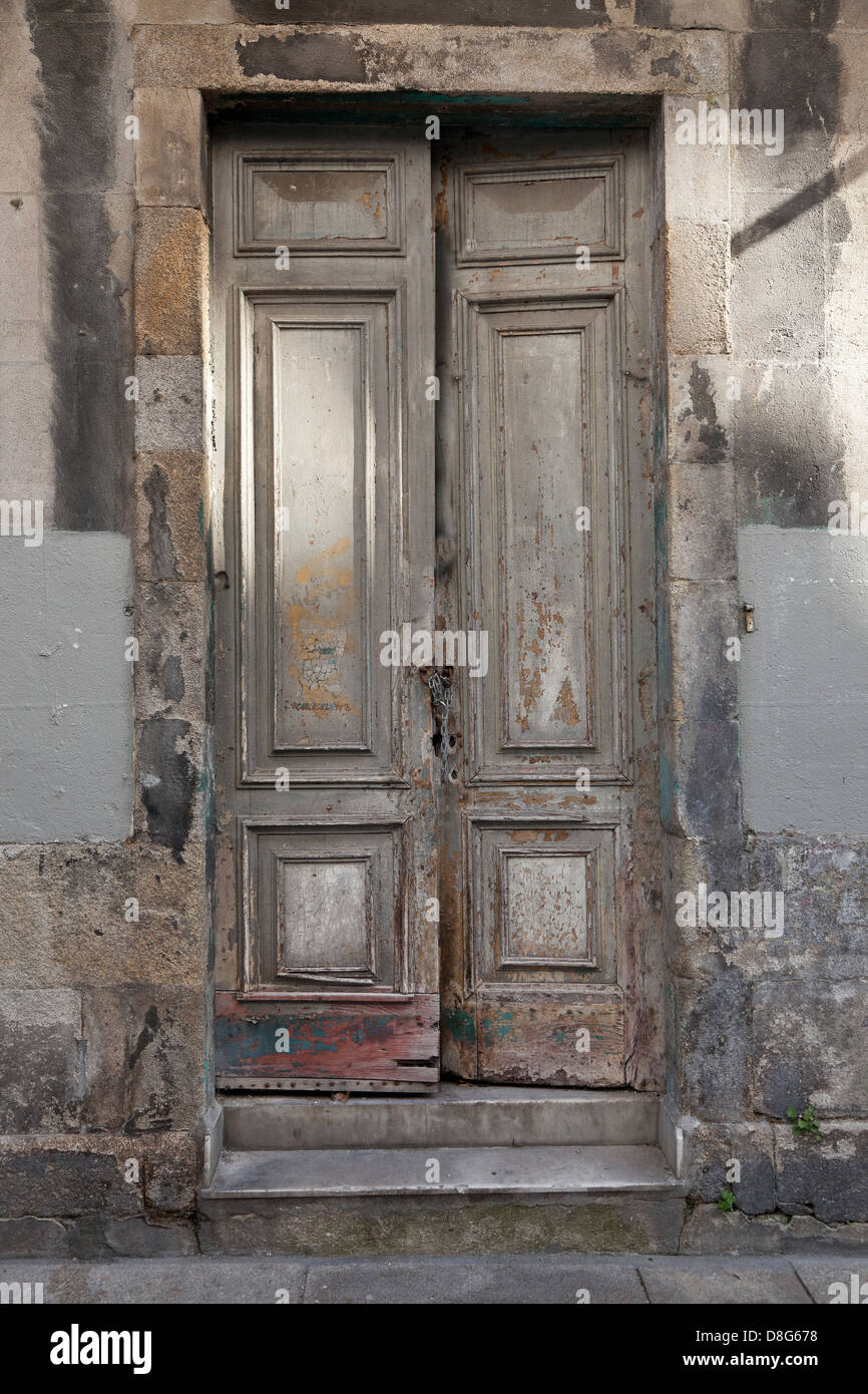 Shabby Chic, very tall vintage panel wooden door, poor condition, derelict Stock Photo