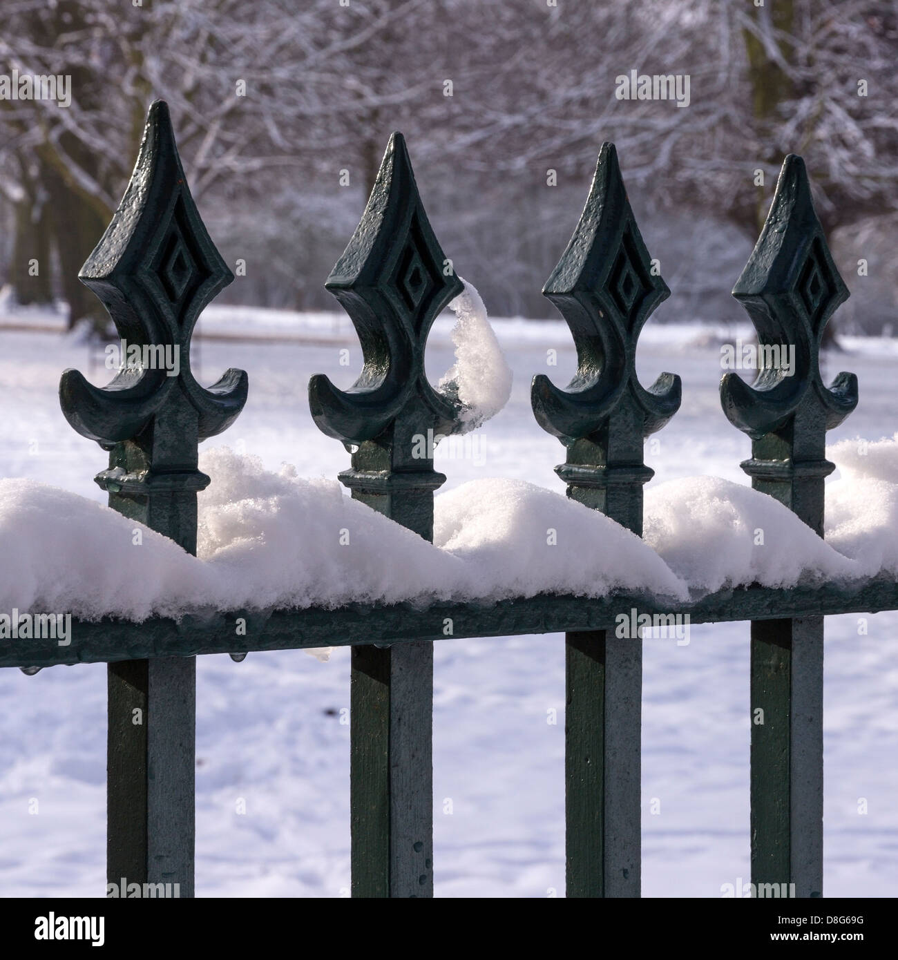 Snowy iron metal fence railings with finials, UK Stock Photo