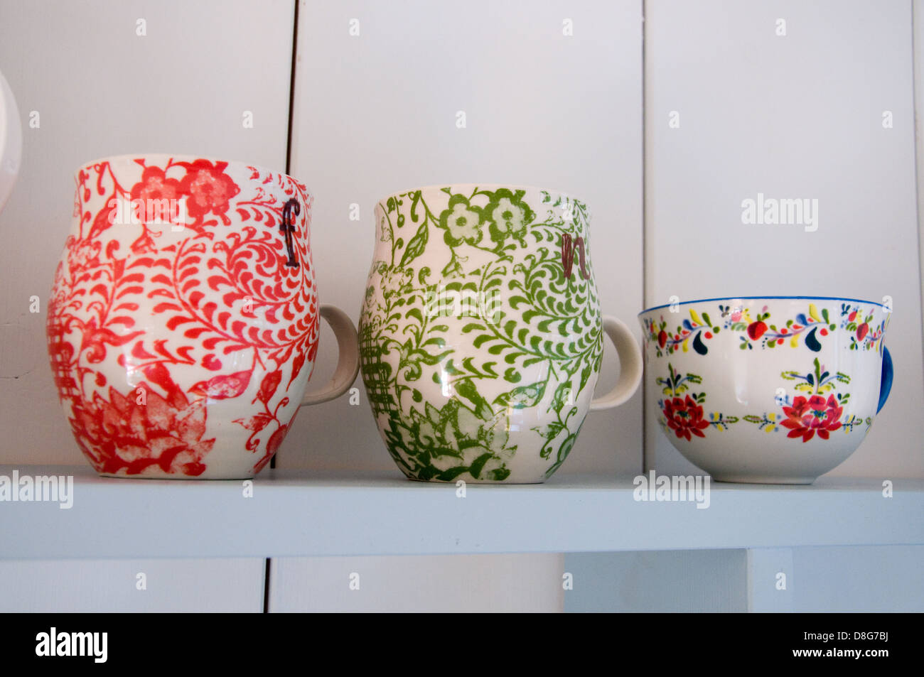 Colourful English mugs lined up on a shelf Stock Photo Alamy