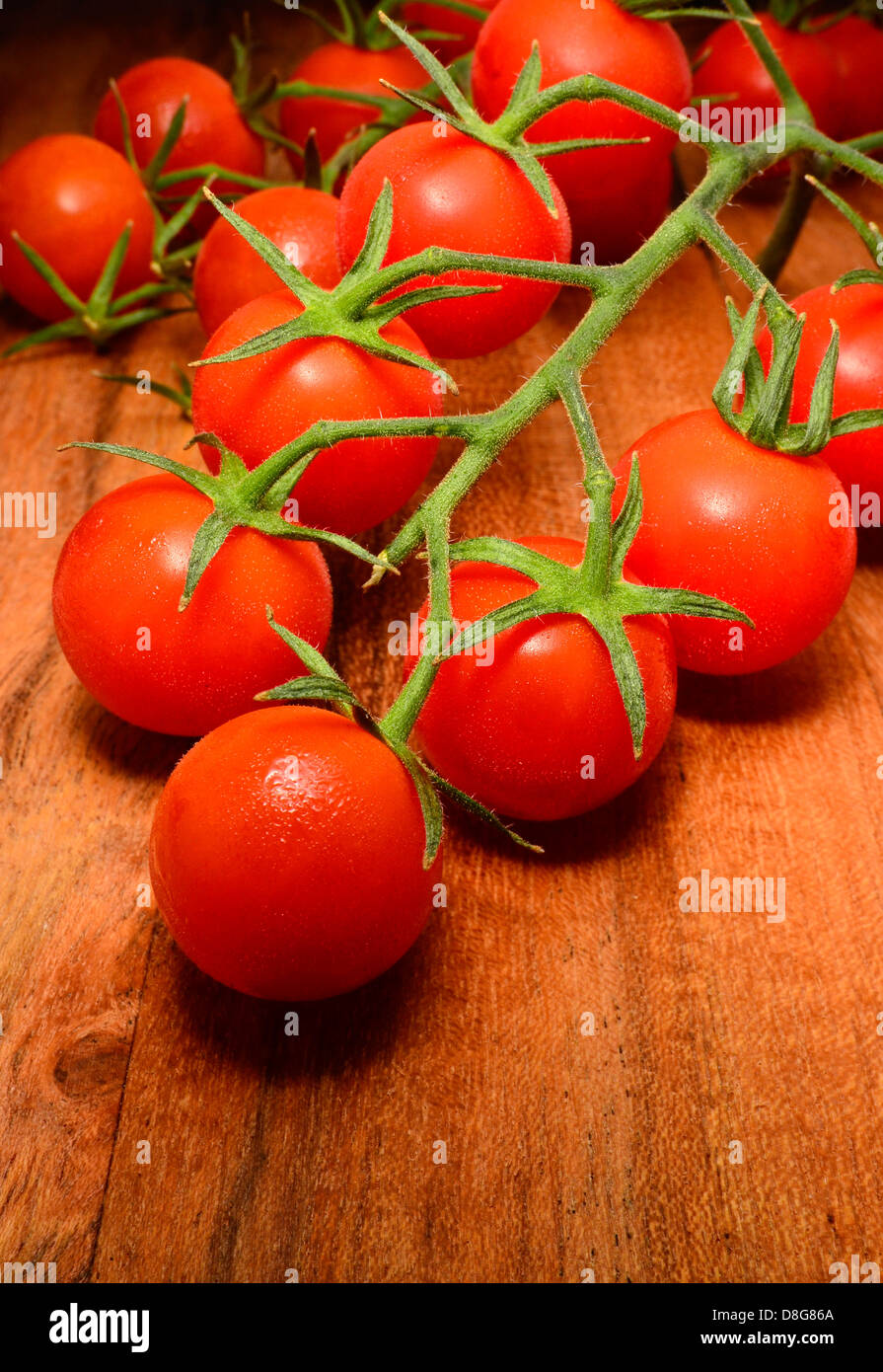 cherry tomatoes on chopping board Stock Photo - Alamy