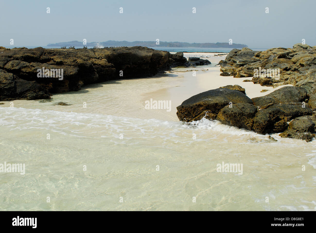 Waves breaking on the rocks at the shore of Chapera island Stock Photo