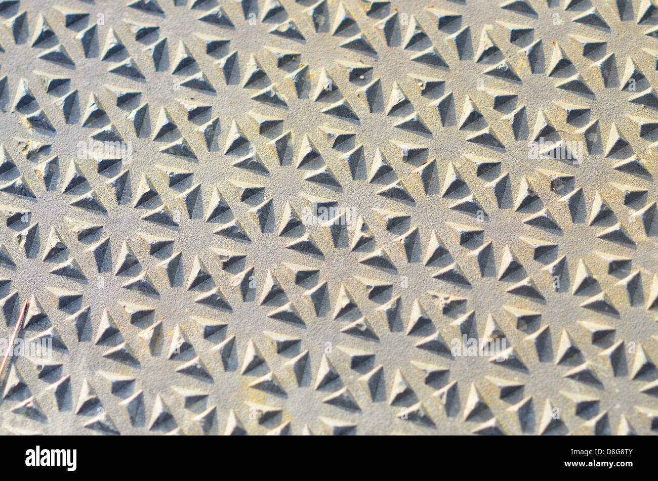 abstract pattern on metal man hole cover Stock Photo