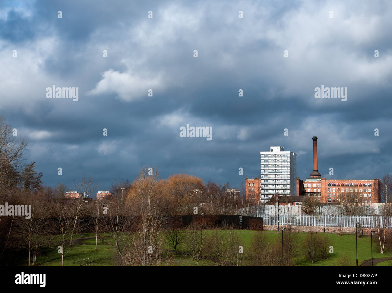 An old mill and council estate building on Manchester skyline Stock Photo