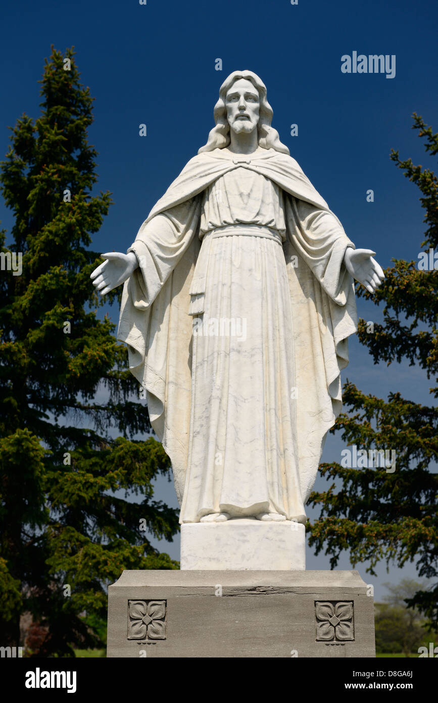 Marble statue of Jesus Christ the Saviour in a cemetery outdoors with
