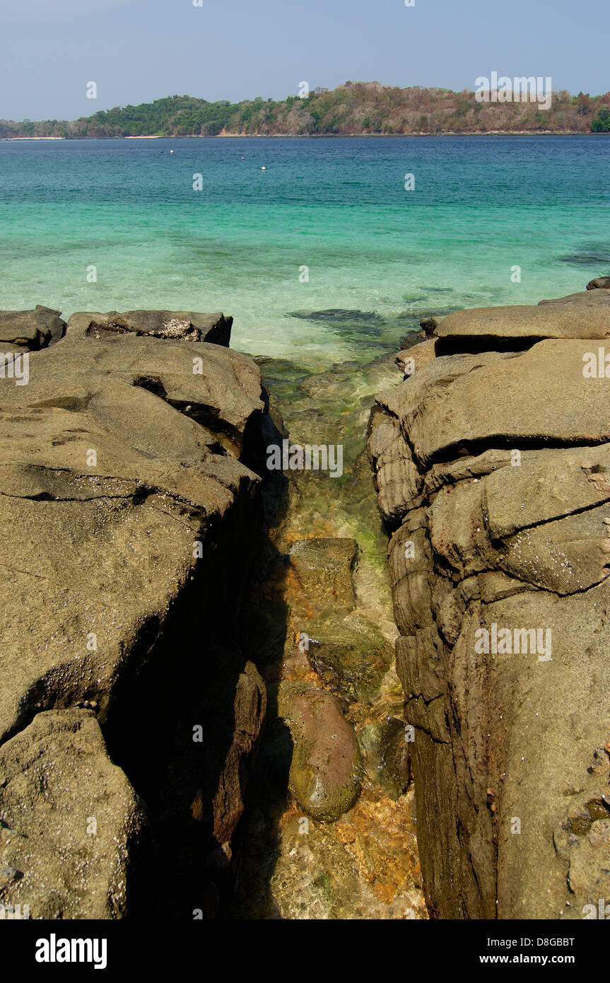 Sea waters entering between rocks in Contadora island shore Stock Photo