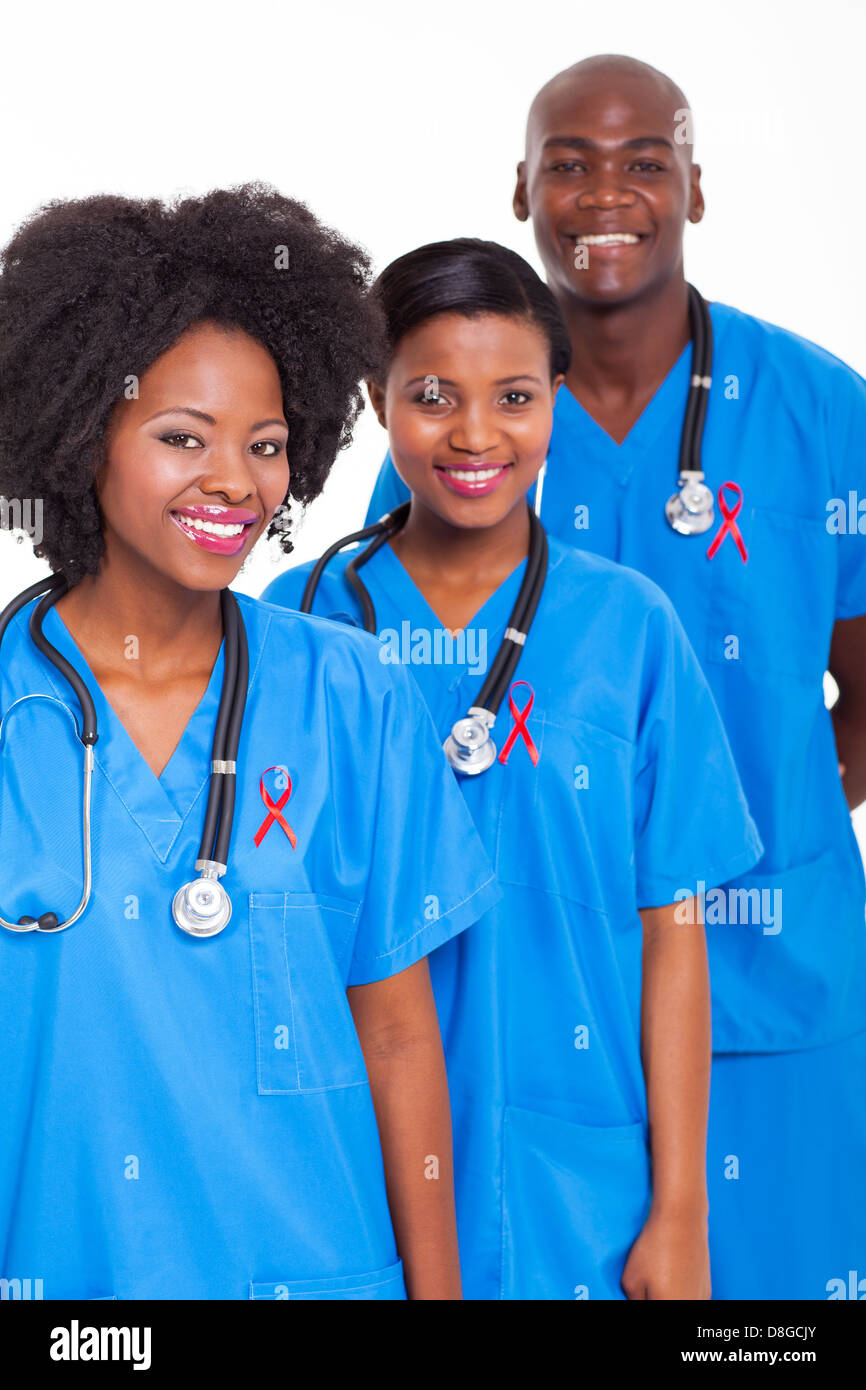 group of African medical workers with red ribbon for HIV awareness Stock Photo