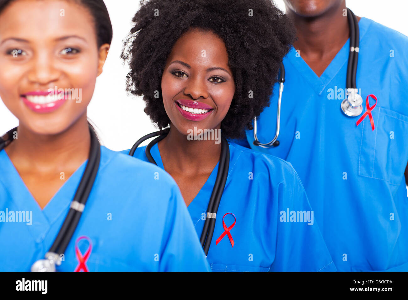group of happy African healthcare workers with red ribbon for AIDS awareness Stock Photo