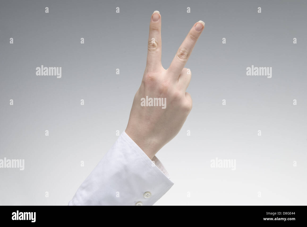 Woman's hand showing Victory symbol Stock Photo