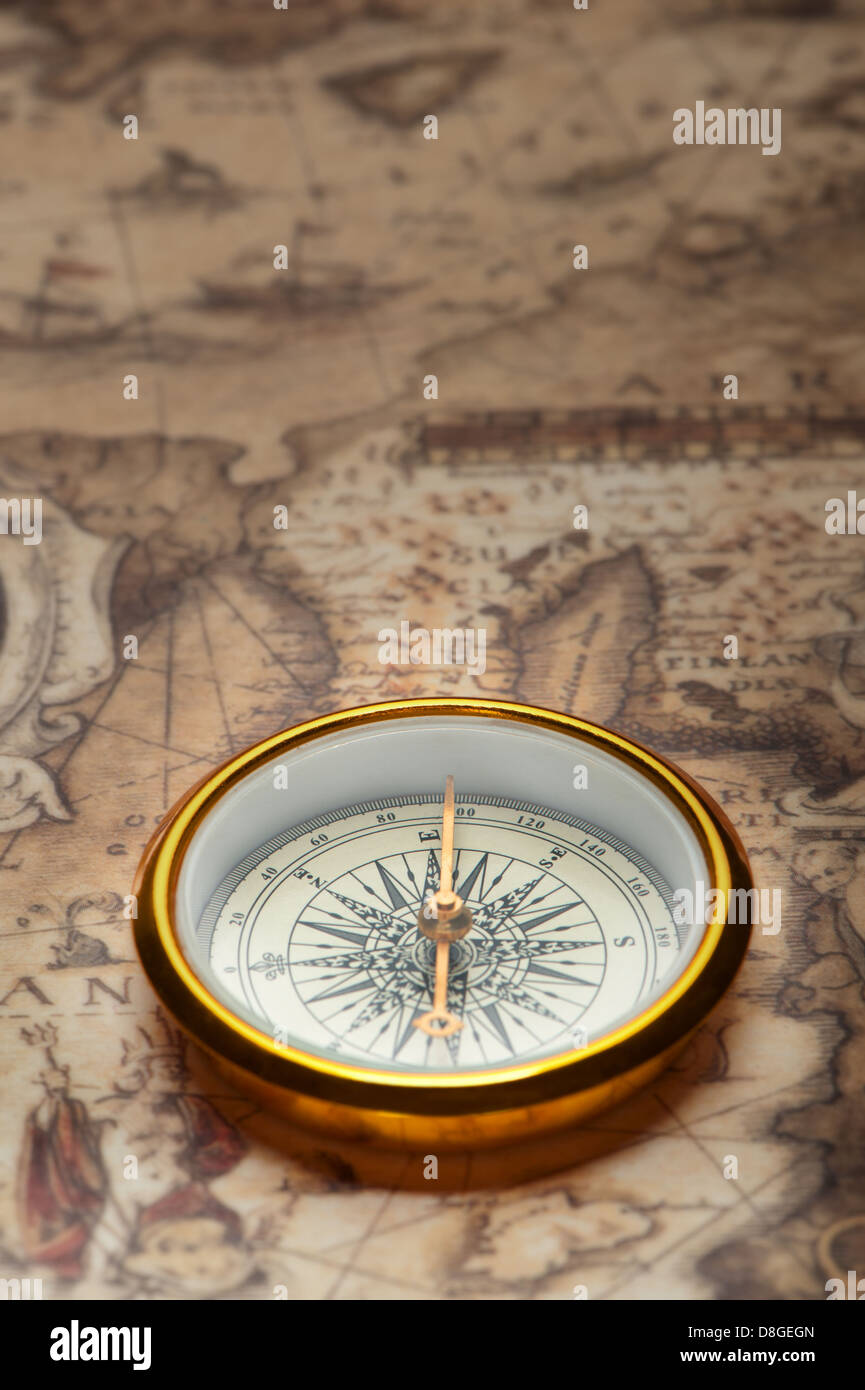 Old compass on ancient map Stock Photo