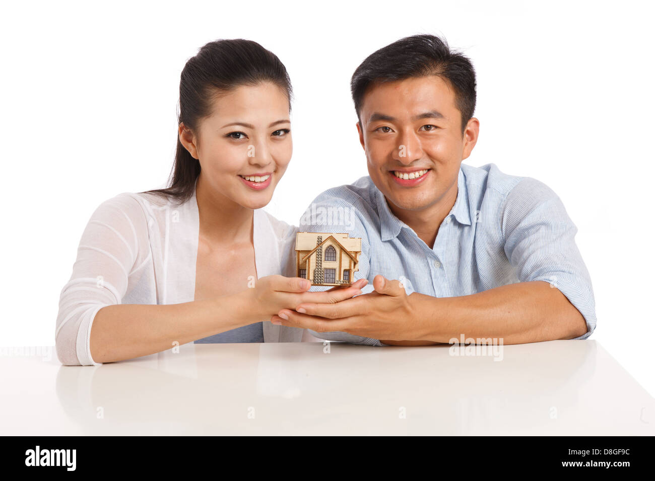 Young couple holding house model Stock Photo - Alamy