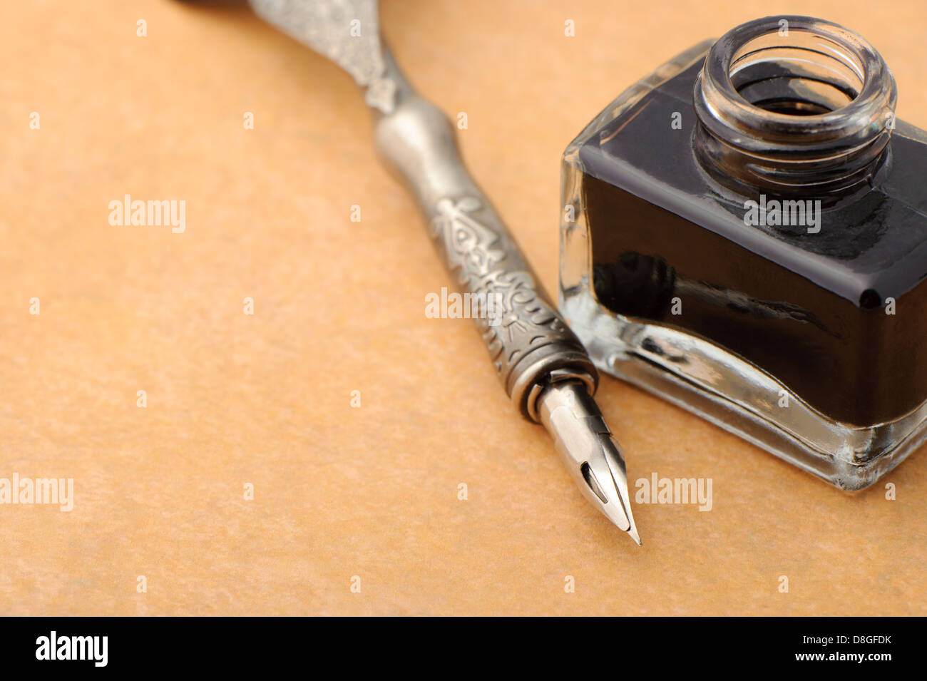 Feather quill and inkwell on an old paper Stock Photo - Alamy