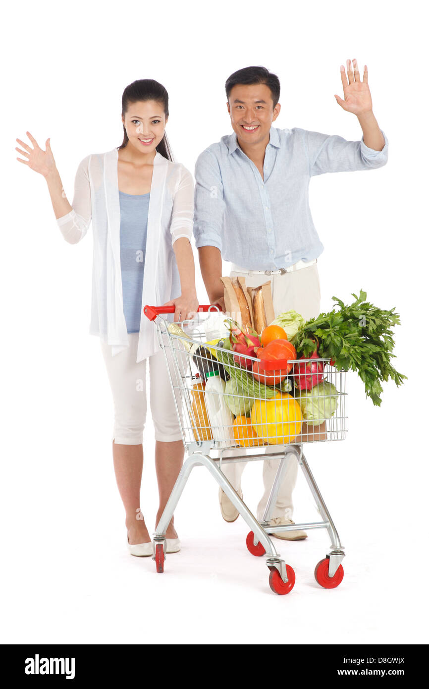 Young couple shopping with shopping cart Stock Photo