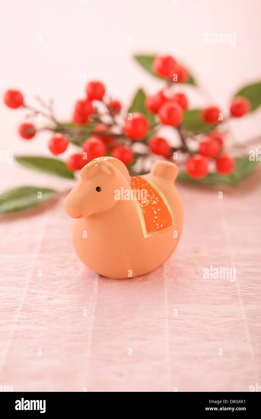 Toy Horse and Red Berry on Pink Paper Stock Photo