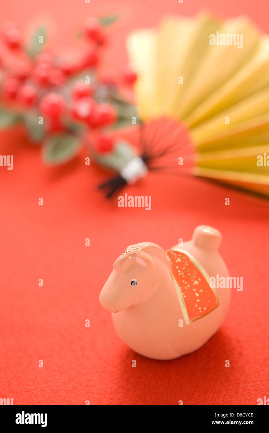 Toy Horse, Fan and Red Berry on Red Background Stock Photo