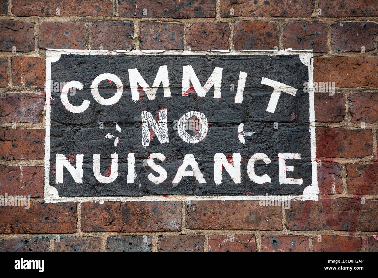 Commit No Nuisance. A sign of an older age on a city wall in Melbourne Australia. Stock Photo