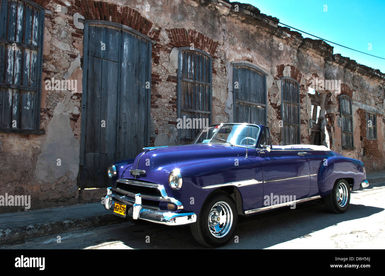 Cojimar Havana Cuba old Classic 1953 Chevy against worn stone wall in Ernest Hemingway city of Cojimar Stock Photo