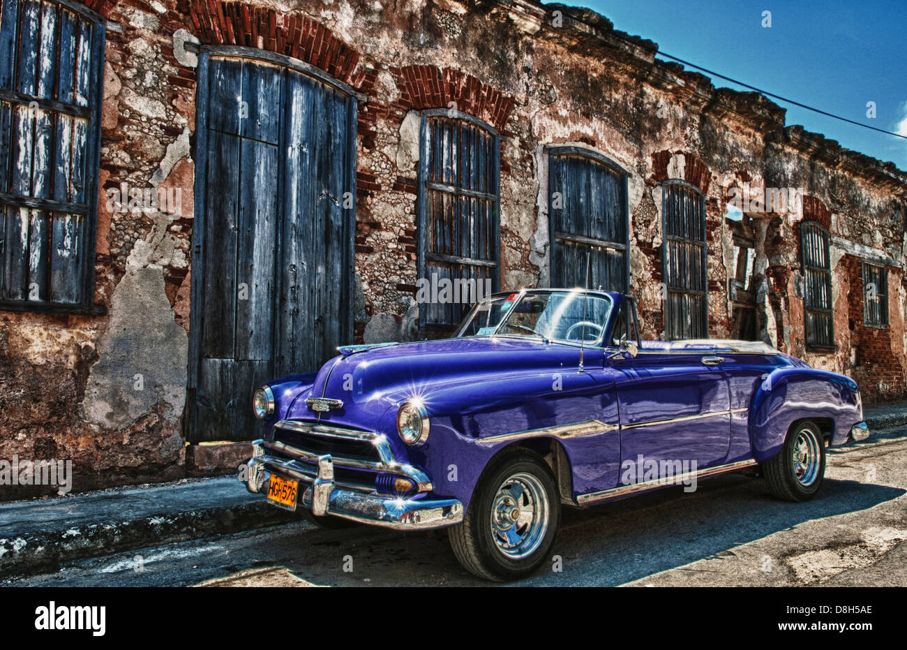 Cojimar Havana Cuba old Classic 1953 Chevy against worn stone wall in Ernest Hemingway city of Cojimar Stock Photo