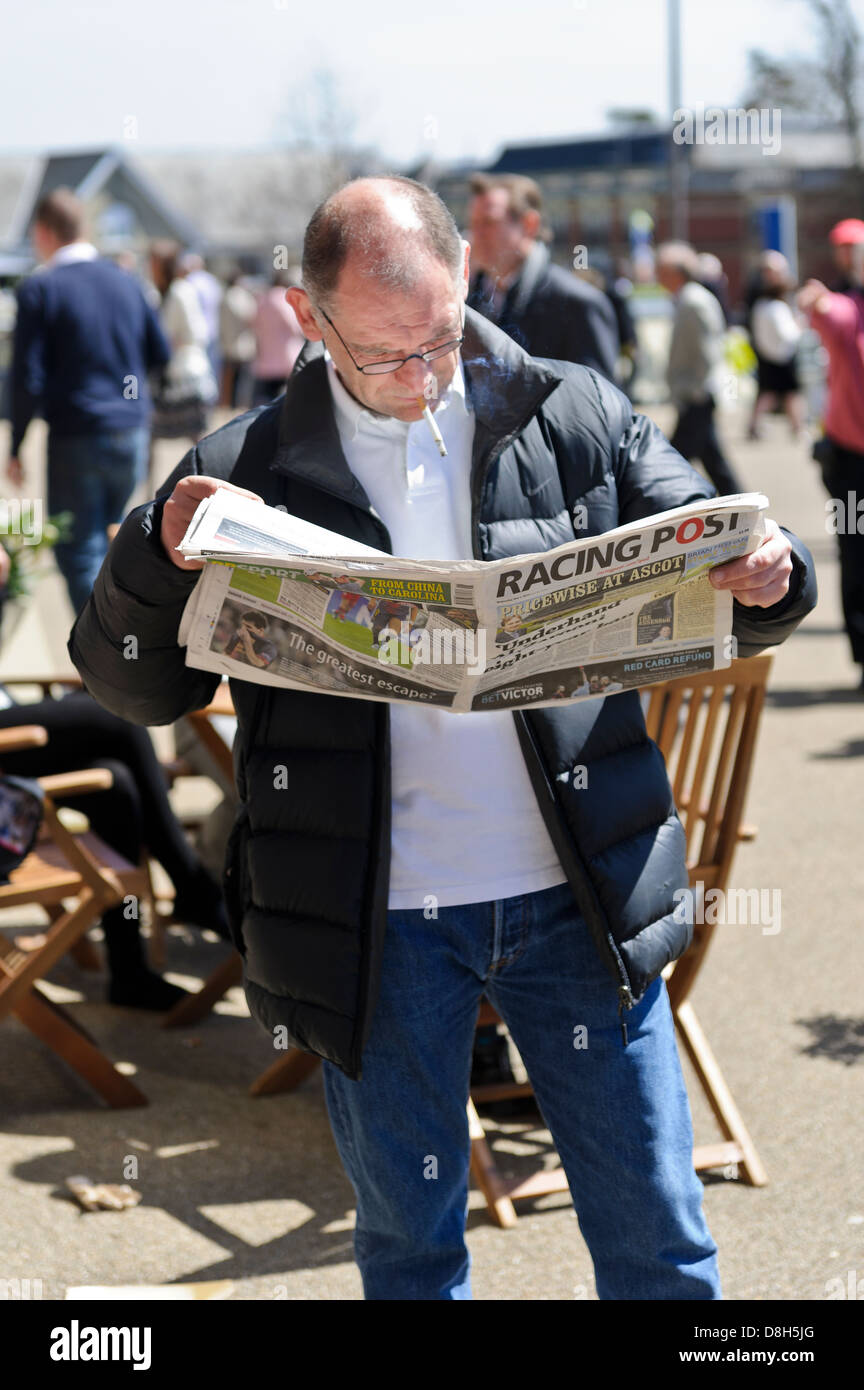 Man Reading Racing Post Newspaper Ascot Racecourse West Berkshire monday-s-racing-post-front-page-story-in-demand-to-retain-his-crown