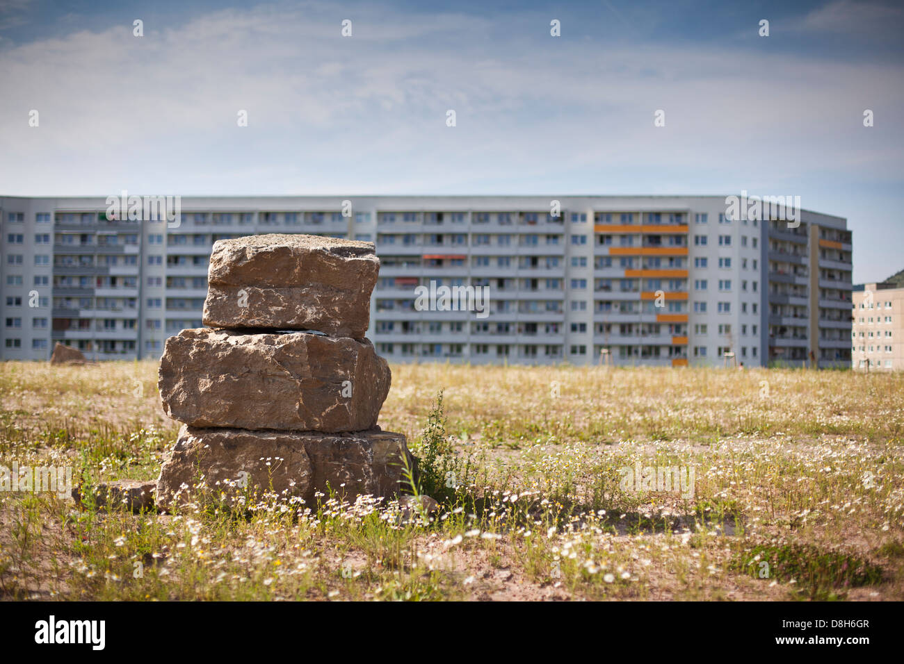 Stacked stones in front of prefabricated buildings, Jena, Thuringia, Germany Stock Photo