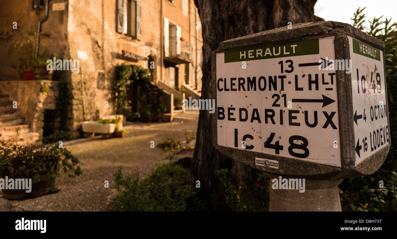 Old road sign for directions to Clermontl'Hérault and Bedarieux