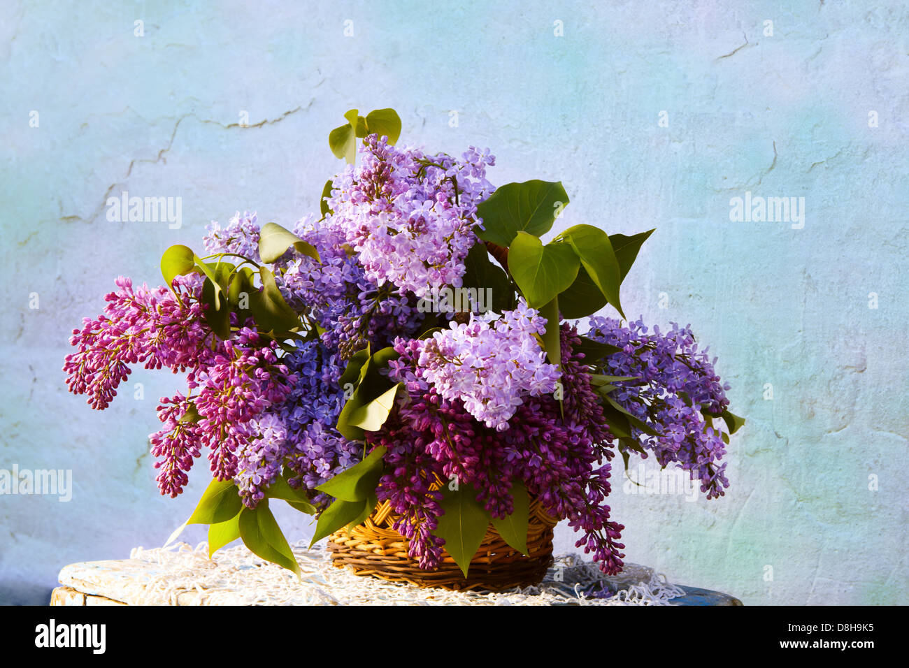 beautiful bouquet of lilacs in a basket. beautiful composition of flowers in basket in vintage style Stock Photo