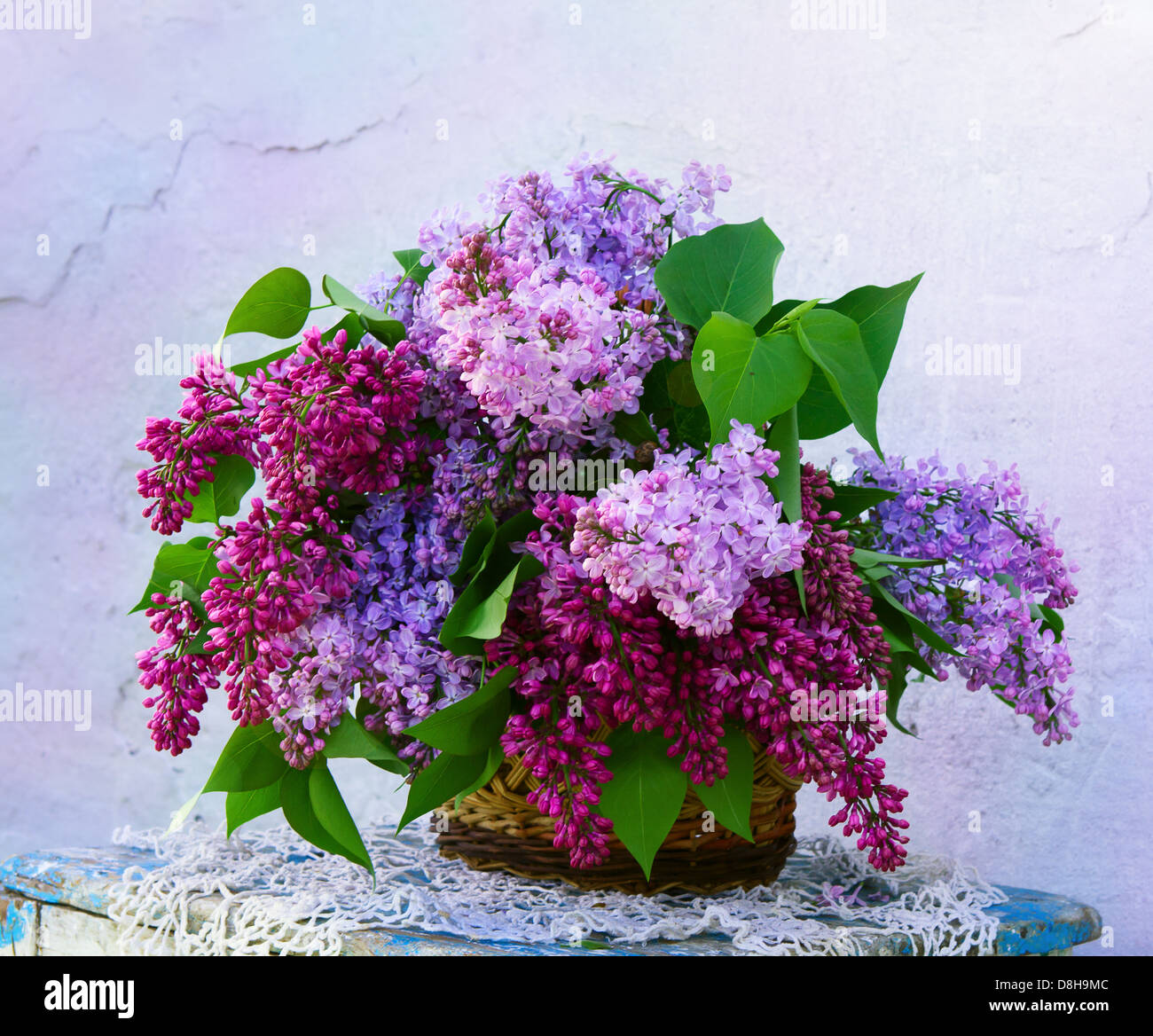 beautiful bouquet of lilacs in a basket. beautiful composition of flowers in basket in vintage style Stock Photo
