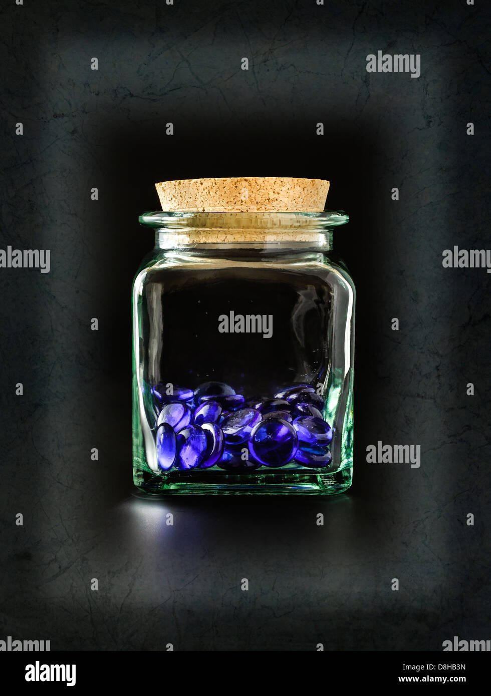 Decorative blue glass stones in glass container Stock Photo Alamy