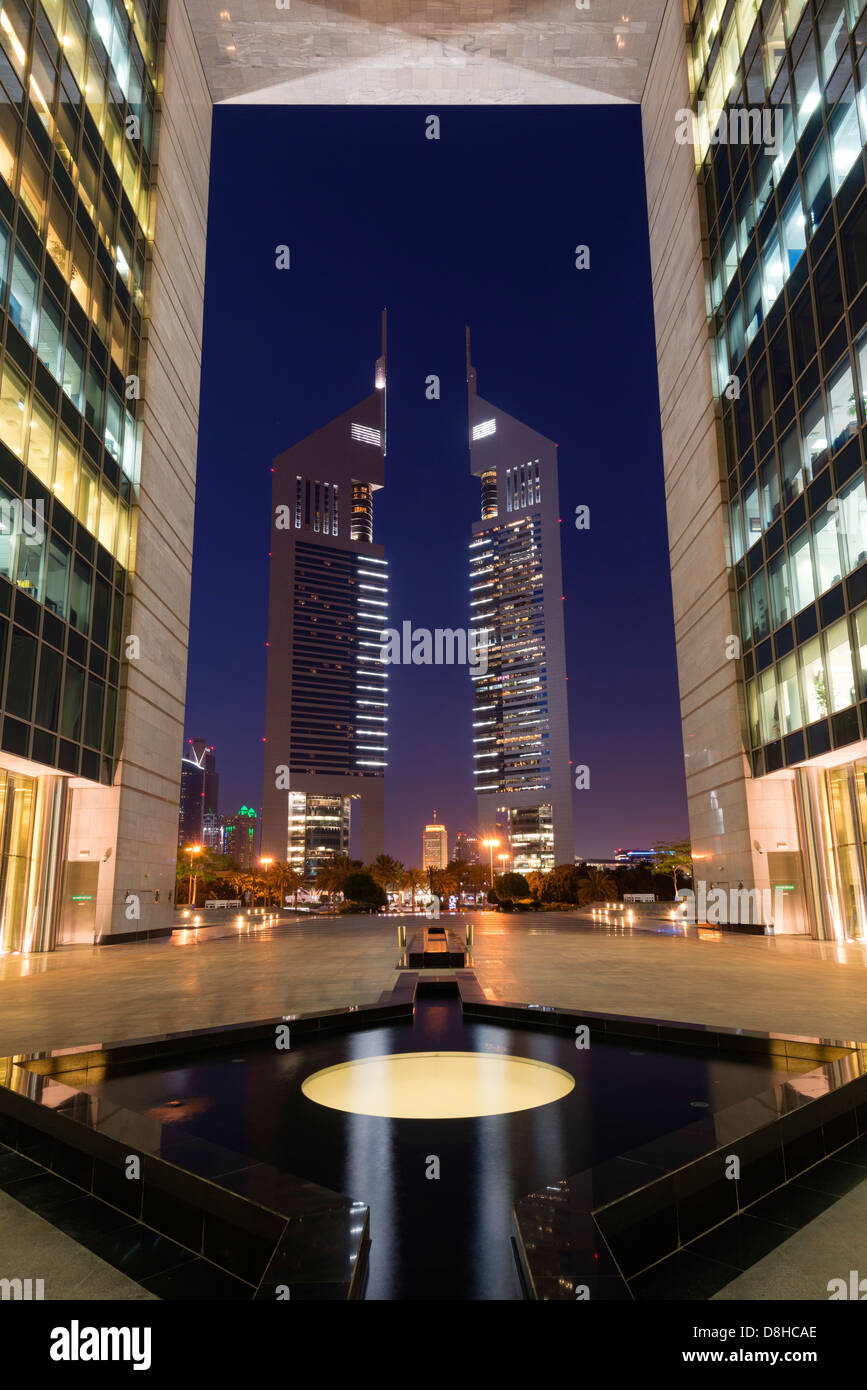 Night view of Emirates towers from The Gate at DIFC or Dubai International Financial Center in Dubai Stock Photo