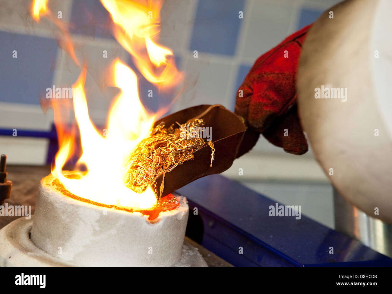Recycling scrap gold to make a molten gold bar at the London Assay Office in Gutter Lane Photo Credit: David Levenson Stock Photo