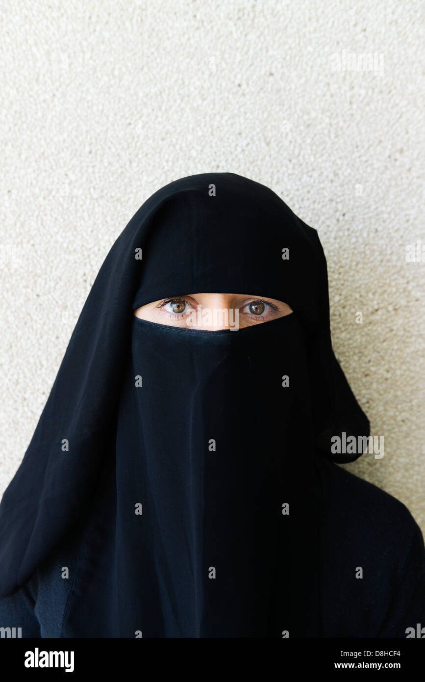 Arab woman wearing traditional black niqab face covering Stock Photo