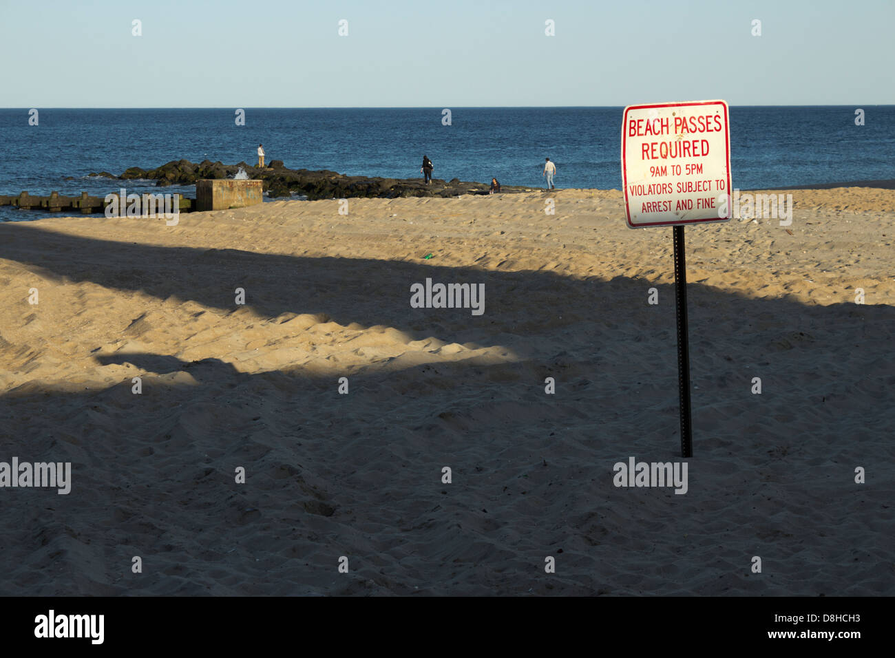 Empty Beach and Passes Required sign, Ocean Grove, NJ, USA Stock Photo