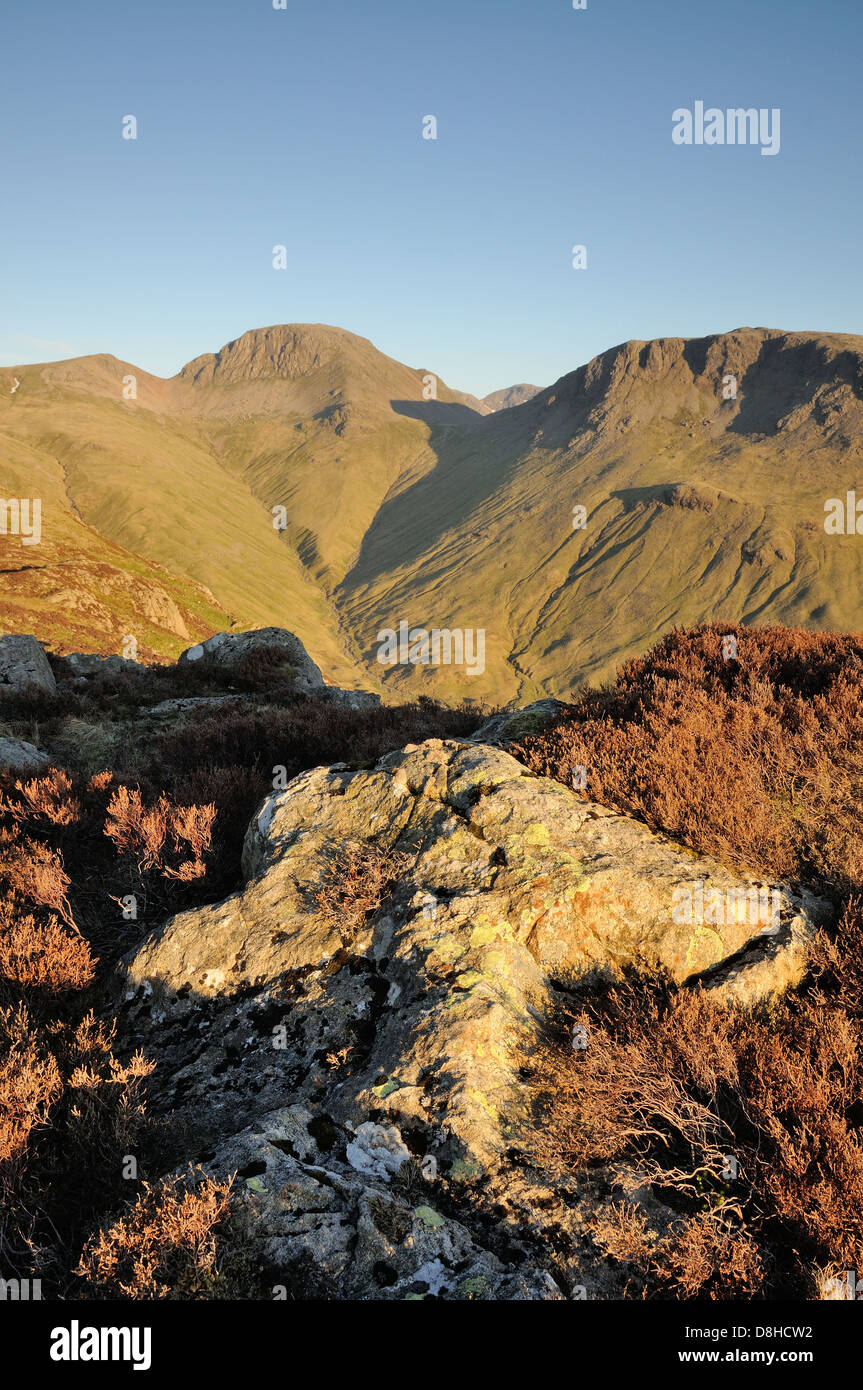 View towards Great Gable and Kirk Fell from Haystacks in evening sunlight in the English Lake District Stock Photo