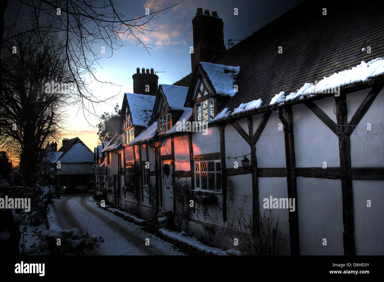 Great Budworth timber tudor thatched cottages In the snow, winter 2010, Northwich, Cheshire, England, UK. These are listed. Stock Photo