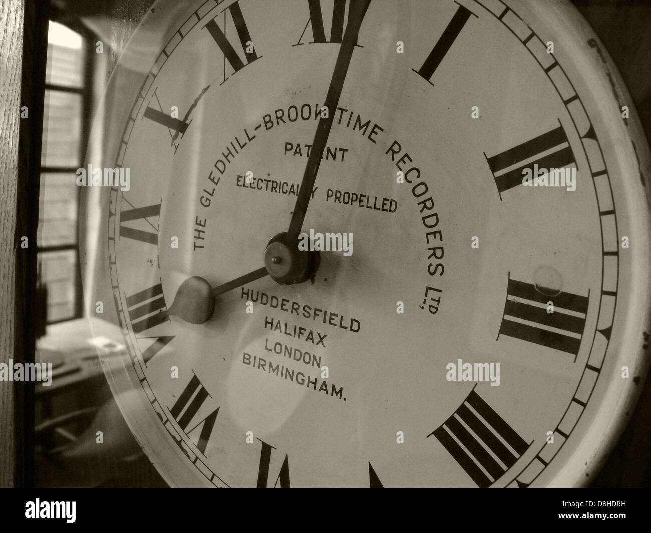 The Gledhill Brooktime Recorders Ltd, Clocking in timeclock, sepia, roman numerals Stock Photo