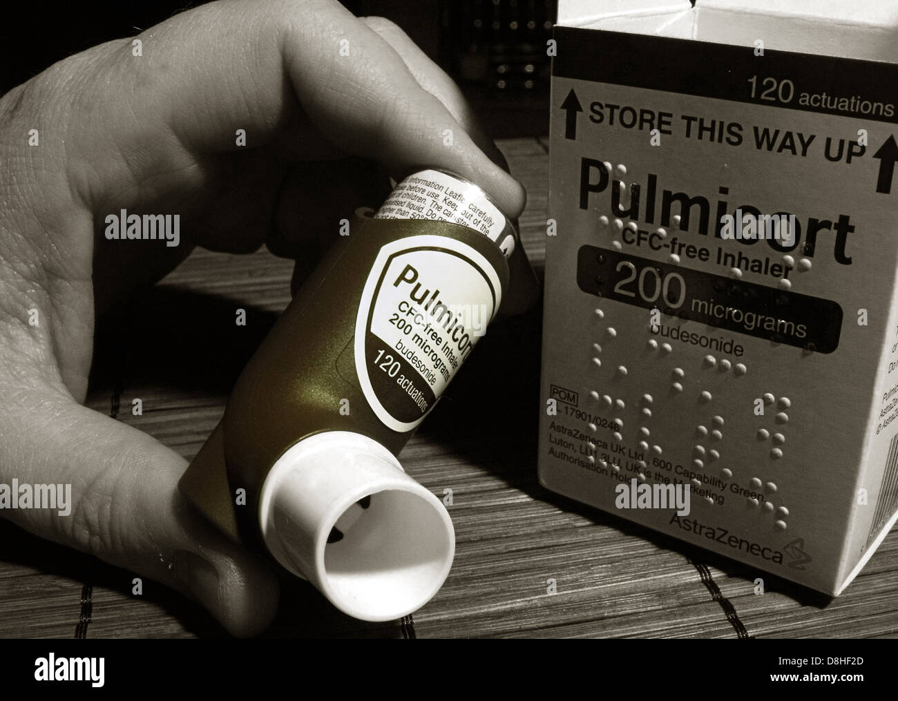 Pulmicort Asthma Inhaler with box with braille markings, held by a user Stock Photo