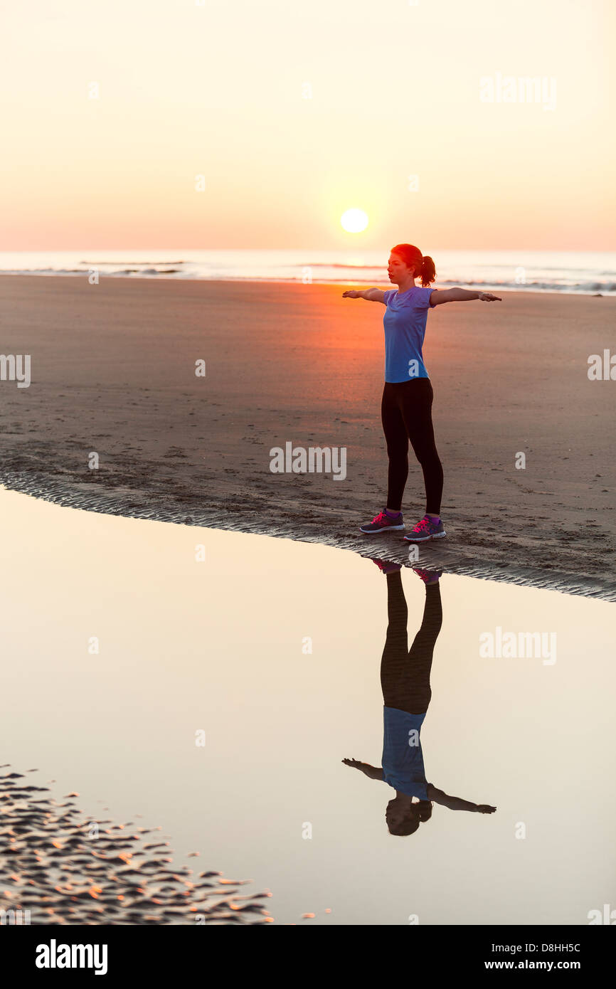 Athlete stretching near ocean Stock Photo