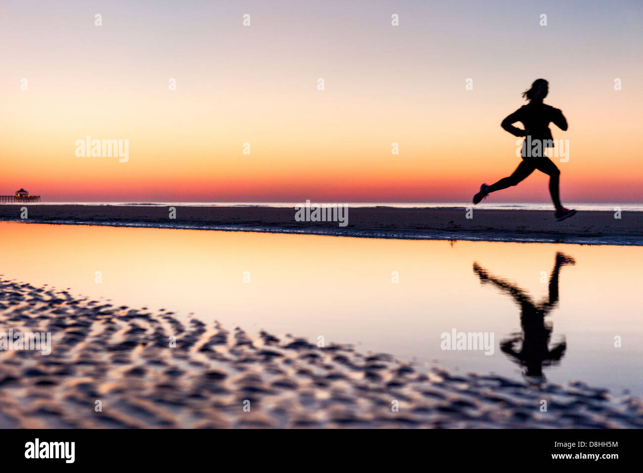 Female jogger at beach Stock Photo