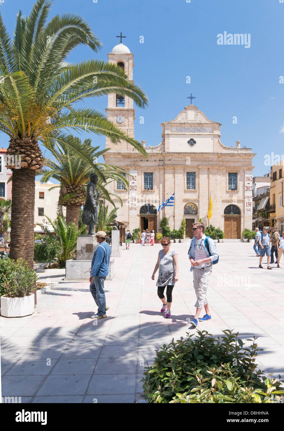 People walking across the square in front of Chania cathedral, Crete, Greece. Stock Photo