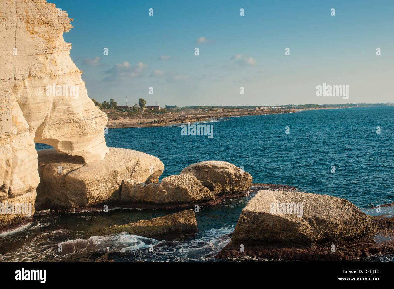 The northernmost shore of Rosh Hanikra, Israel, near the lebanese border. Israeli village in background. Stock Photo