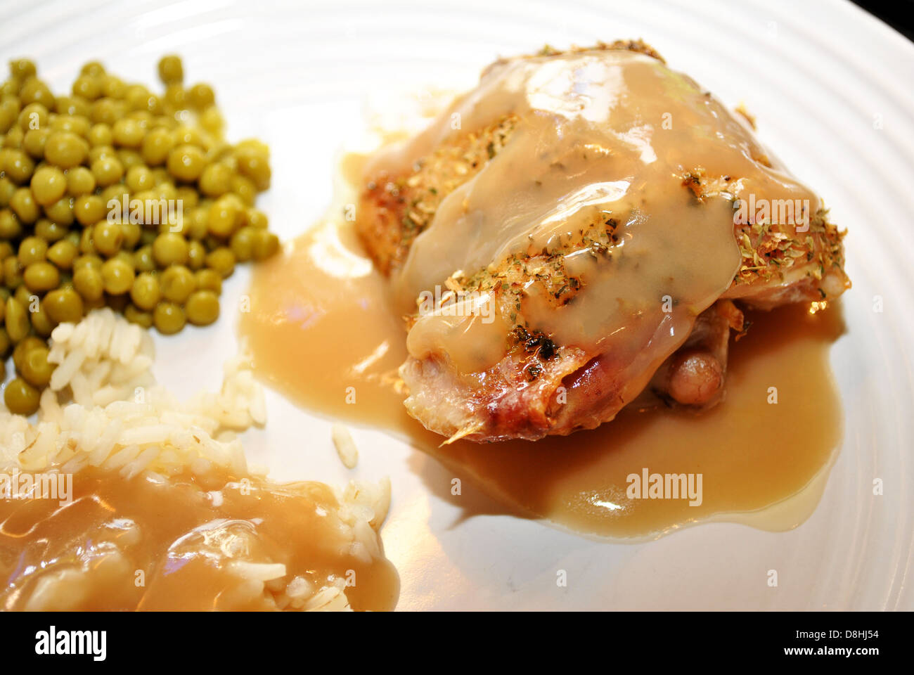 Chicken with Gravy Dinner and White Rice and Peas Stock Photo Alamy