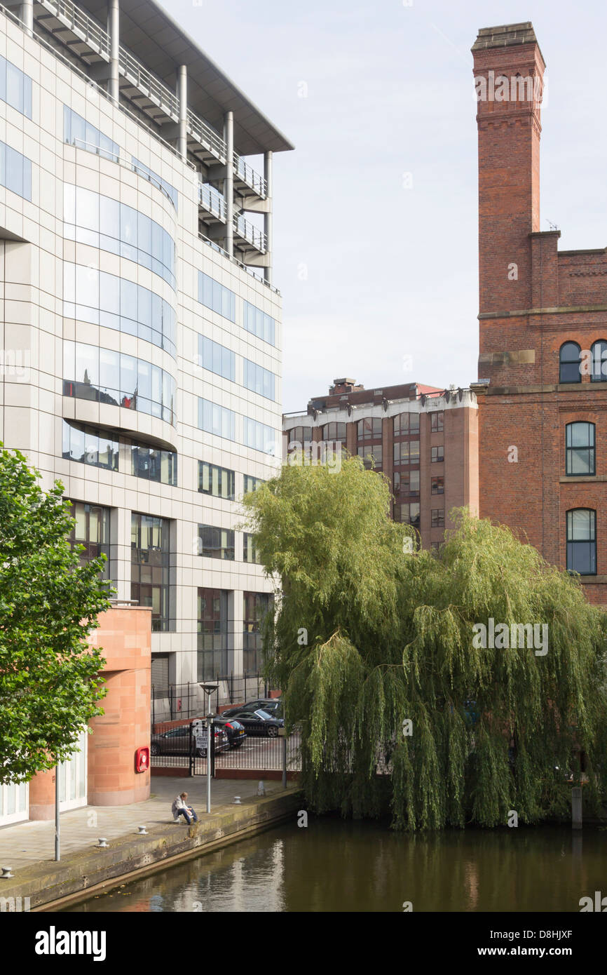 Old  industrial and new office buildings juxtaposed in Barbirolli Square Manchester, part of the Great Bridgewater development. Stock Photo