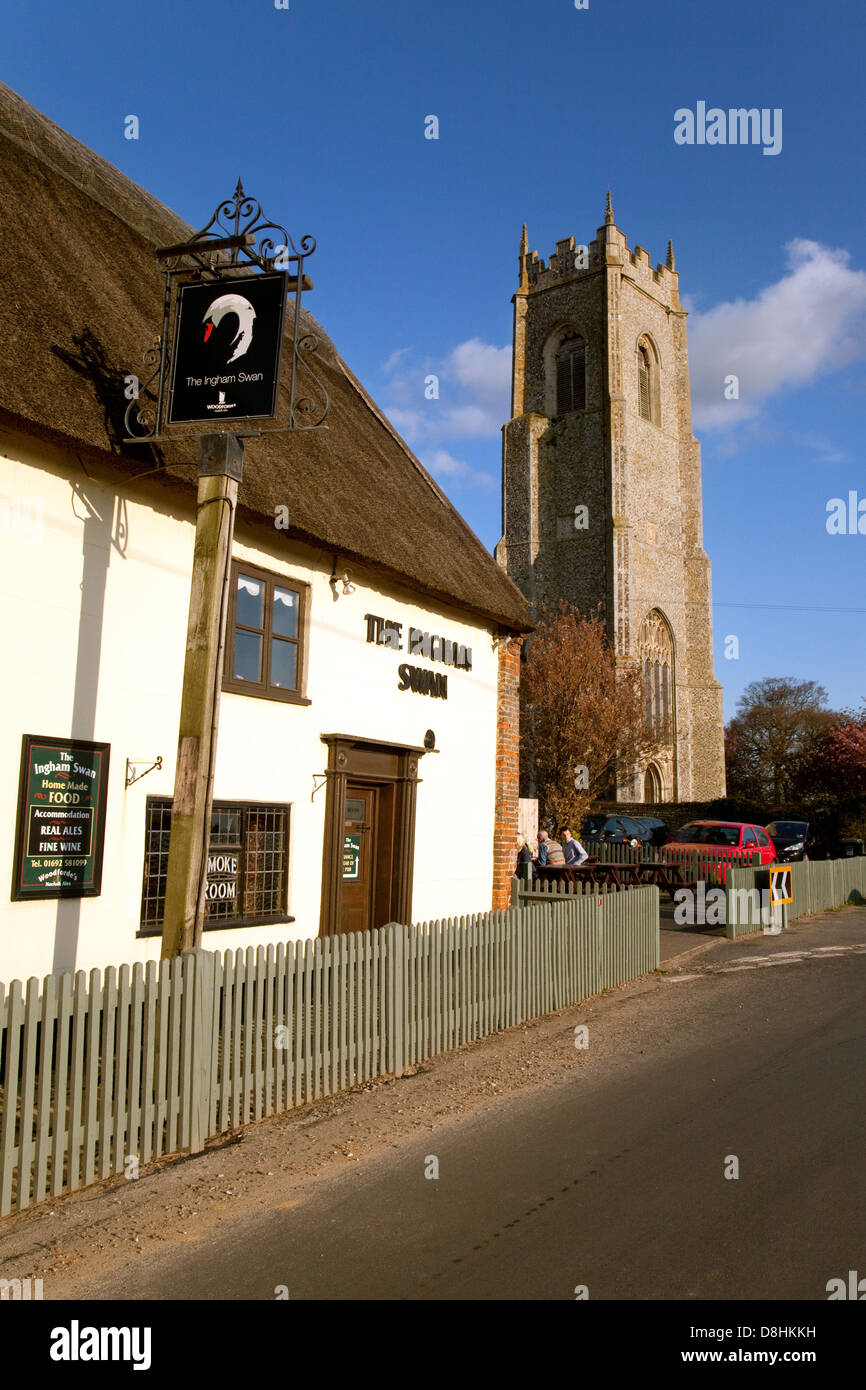 The Ingham Swan pub inn, and Holy trinity Church, Ingham village Norfolk, East Anglia UK Stock Photo