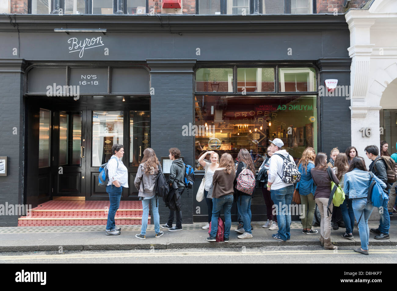 A queue of young people outside the Byron Hamburger restaurant Beak Street London UK Stock Photo