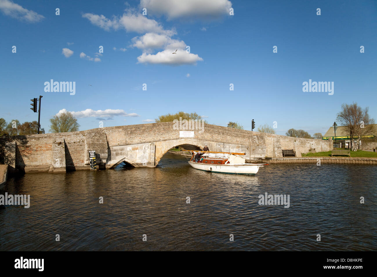 A sailboat coming under the bridge on the River Thurne at Potter Heigham, Nofolk Broads UK Stock